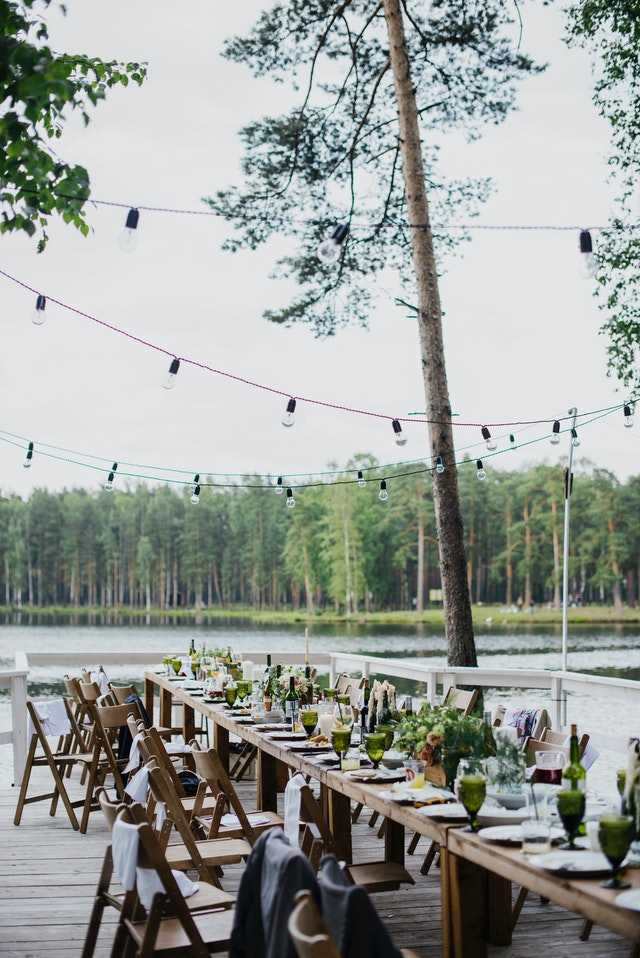 banquet wooden table and chairs on terrace near lake 3951652 - Simple Wedding Planning Checklist for the Practical Bride - The National Wedding Directory